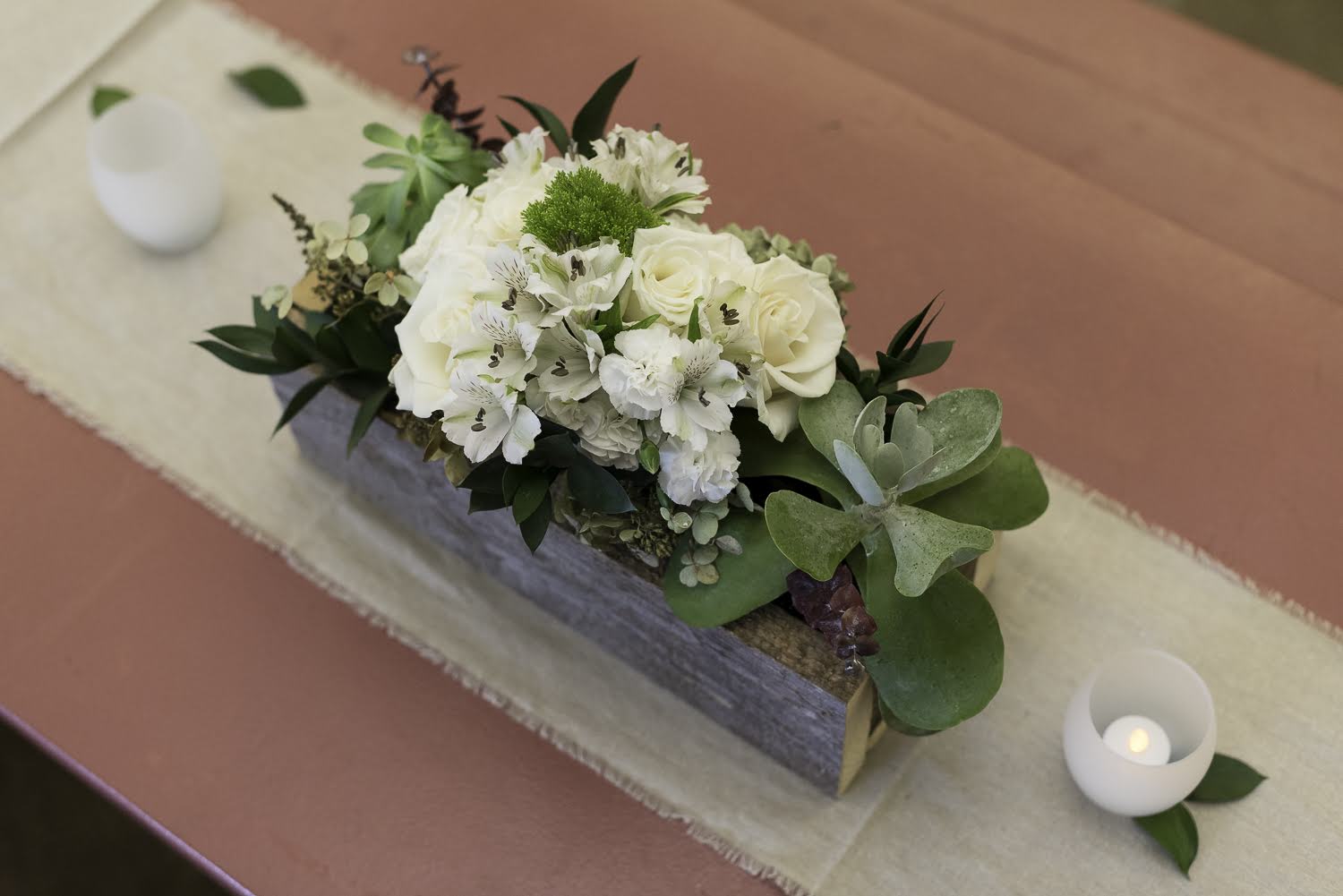 The flower-filled centerpiece made from rustic pine.