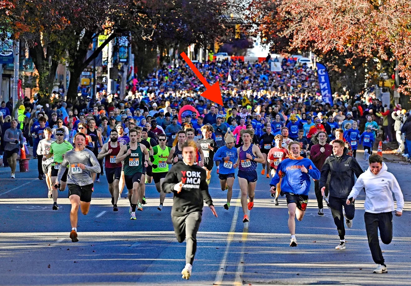 The Turkey Trot crowd running from the starting line, my corn costume
emerging in the background.